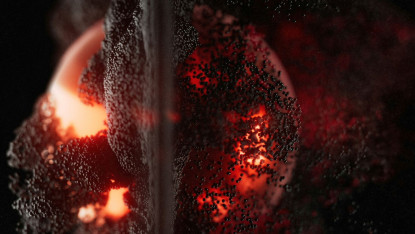 Abstract close-up of a textured surface with glowing red-orange light beneath, resembling lava or molten material. Dark particles scatter across, creating a dramatic and intense atmosphere.