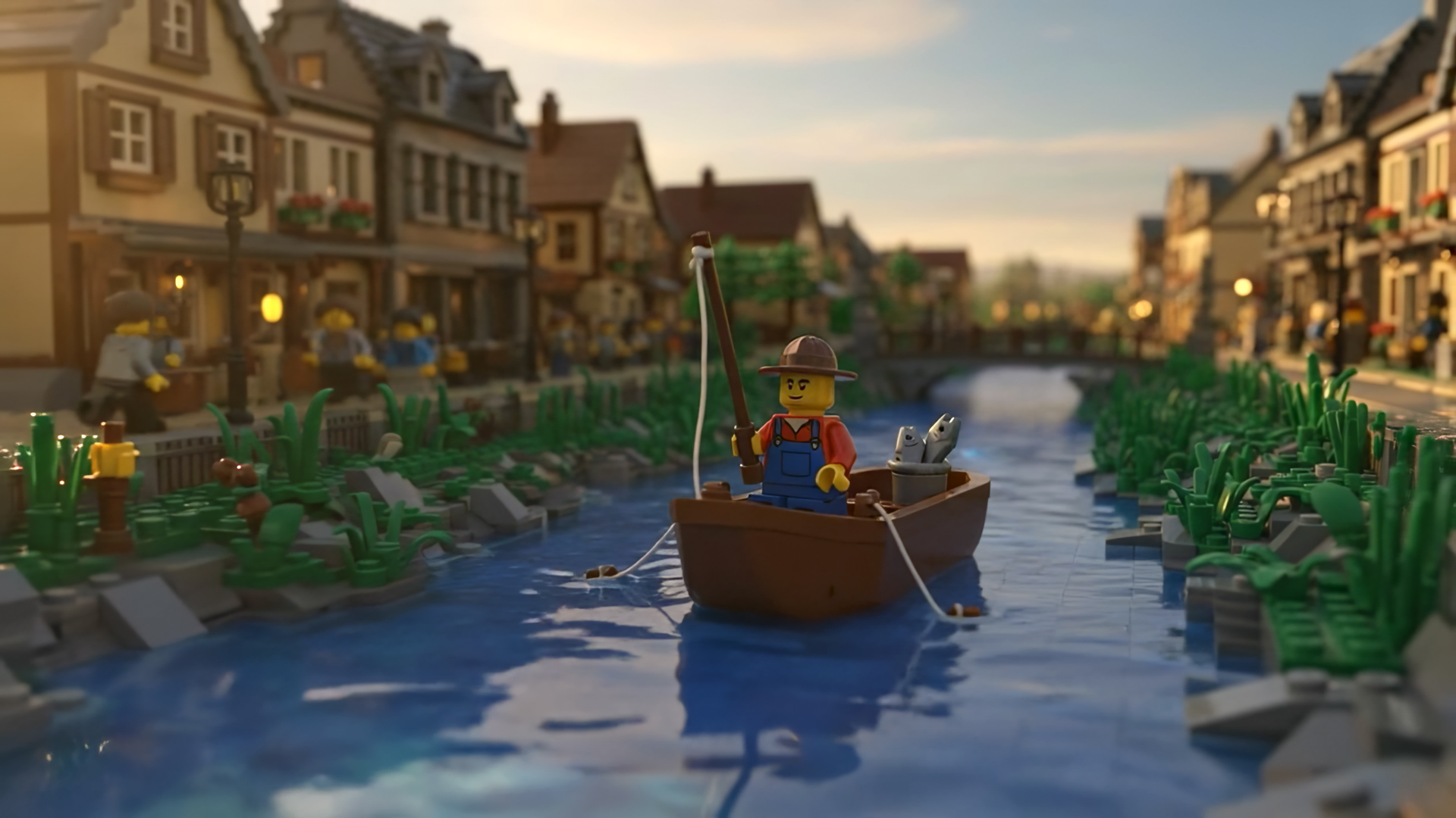 A LEGO figure in a boat fishes on a tranquil river, flanked by detailed LEGO buildings resembling a quaint village. The scene evokes a peaceful, idyllic setting.