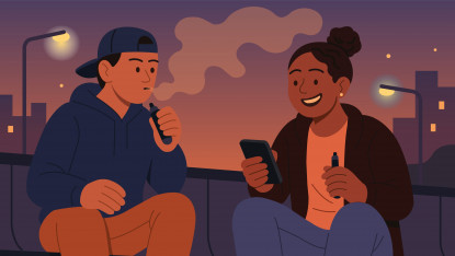 Two people sitting outdoors at dusk, vaping and smiling. One wears a cap, and the other holds a phone. Streetlights and cityscape in the background.